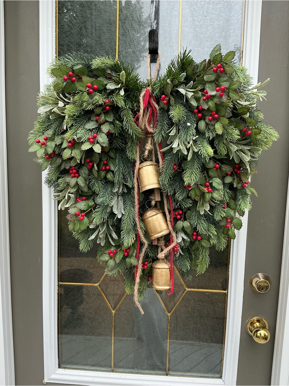 Heart-Shaped Green Holiday Wreath with Red Berries and Gold Bells